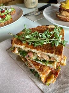 a sandwich sitting on top of a plate on a table at Roamer St Kilda in Melbourne