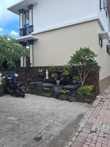 a scooter parked in front of a building at Jukung Villas Kuta in Kuta