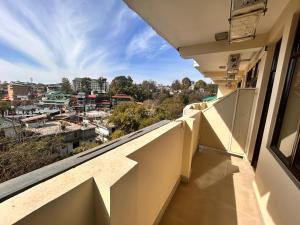 a balcony with a view of a city at Hotel Rongla in Pālampur