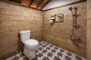 a bathroom with a toilet and a shower at Dapur Alit Villas in Yogyakarta