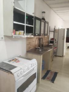 a kitchen with a stove and a sink at 3-bedroom house on Cabuçu beach in Saubara +9 photos