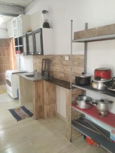 a kitchen with a counter with pots and pans at 3-bedroom house on Cabuçu beach in Saubara