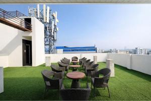 a patio with a table and chairs on a roof at FabHotel Lake View Castle in Warangal