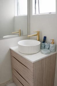 a bathroom with a sink and a mirror at Rayya Suites, Paihia in Paihia +37 photos