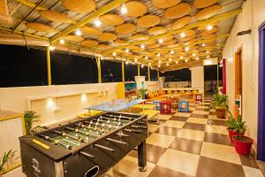 a room with a bar with a table and chairs at goSTOPS Amritsar, Golden Temple in Amritsar