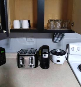 a kitchen counter with a toaster and a coffee maker at Cosy single-level home with laundry and parking in Huntington
