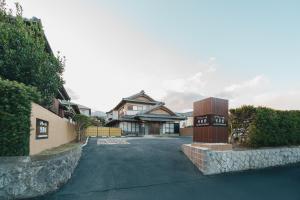 a house with a driveway in front of a house at アリュール照波園 in Beppu