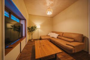 a living room with a couch and a coffee table at アリュール照波園 in Beppu