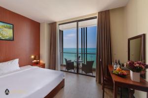 a hotel room with a bed and a view of the ocean at Amarin Resort & Spa Phu Quoc in Phú Quốc