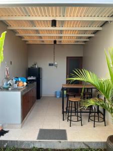 a kitchen with a counter and a table with chairs at Naung CoLiving in Kerobokan +6 photos