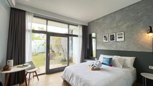 a bedroom with a large bed and a large window at Turuku in Bandung