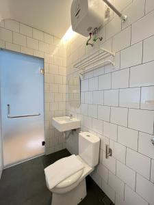 a bathroom with a toilet and a sink at Turuku in Bandung
