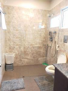 a bathroom with a shower and a toilet at amã Stays & Trails Eagle's Nest, Gangtok, Sikkim in Bhurtuk +32 photos