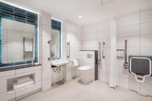 a white bathroom with a sink and a toilet at Hyatt House Aparthotel Leeds in Leeds +42 photos