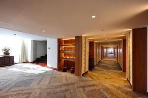 a hallway of a building with wooden doors at Wienglakor Hotel Lampang in Lampang