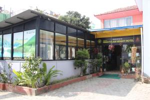 a store front of a building with windows and plants at Bhuwani Himalayan Height Hotel in Kathmandu