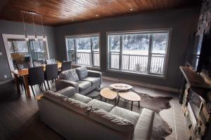a living room with a couch and a table at Lakefront - Chalet Le Missionnaire in Trois Rives