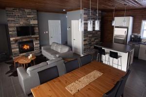 a living room with a couch and a fireplace at Lakefront - Chalet Le Missionnaire in Trois Rives