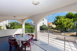 a patio with a table and chairs on a balcony at Apartments Duje in Trogir