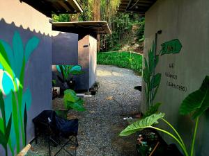 a patio with chairs and plants in a yard at Kalaland in Patong Beach