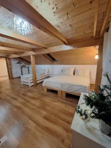 a large room with a bed and a wooden ceiling at Vila pod Dubem in Návsí u Jablunkova