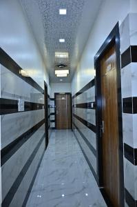 a hallway in a building with doors and a hallway at Hotel Radhe in Bhind