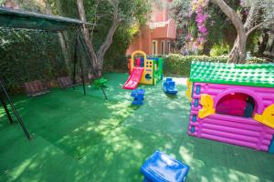 a playground with a play set in a yard at Katre Hotel Oludeniz in Oludeniz