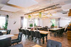 a restaurant with tables and chairs in a room at Waldgasthaus in Hochburg