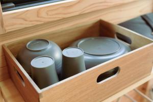a wooden drawer with three vases in it at Shinon 森音 in Tateyama