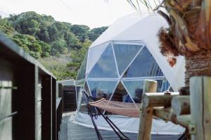 a hammock in a dome tent on a deck at Shinon 森音 in Tateyama