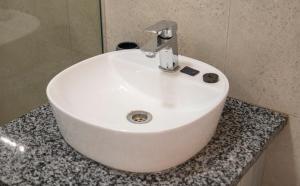 a white sink sitting on a counter in a bathroom at Harmony House in Ladysmith +4 photos