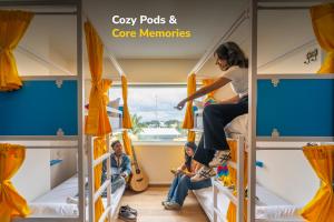 a group of people sitting on bunk beds in a bus at goSTOPS Bengaluru, Jayanagar - Private Rooms & Dorms in Bangalore