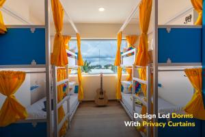 a room with two bunk beds with a guitar at goSTOPS Bengaluru, Jayanagar - Private Rooms & Dorms in Bangalore