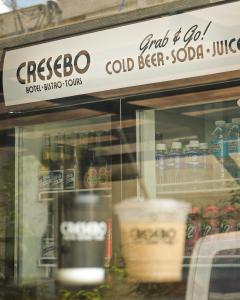 a store window with a sign that reads cespedo cold beer juice at Cresebo Mansion in Tagbilaran City