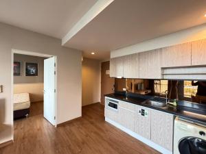a kitchen with a sink and a counter top at Ekkamai Bangkok Condo in Bangkok