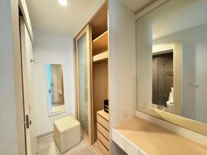 a bathroom with a toilet and a sink and a mirror at Ekkamai Bangkok Condo in Bangkok +42 photos