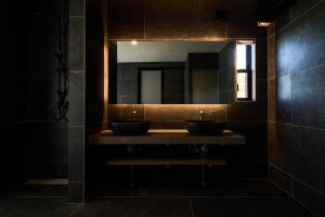 a bathroom with two sinks and a mirror at eureka awaji 絶景インフィニティプール x 露天温水ジャグジー付きヴィラ in Sumoto +46 photos
