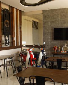 two motorcycles parked in a restaurant with tables and chairs at Cresebo Mansion in Tagbilaran City