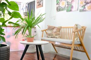 a living room with a bench and plants at Restfull apartment-14 Mai Thuc Lan, My An , Da nang in Danang