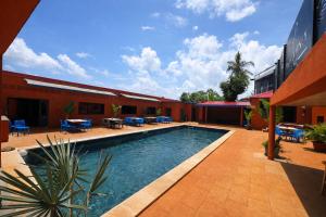 a swimming pool in the courtyard of a building at Le Passamainty Lodge in Mamoudzou