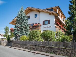 a house with a fence in front of it at Haus Elisabeth in Nova Ponente