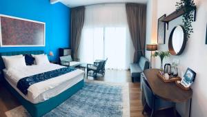 a hotel room with a bed and a desk and a room at Villa Alaya Malai in Setiu +50 photos