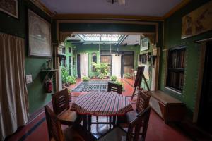 a dining room with a table and chairs at Ram Bhawan Residency in Varanasi