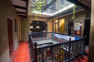 a hallway with a balcony with a wrought iron railing at Ram Bhawan Residency in Varanasi