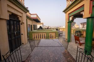 an outdoor patio with chairs and tables on a building at Ram Bhawan Residency in Varanasi