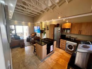 a kitchen with a stove top oven in a room at Hill Fore! in Langebaan