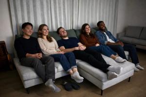 a group of people sitting on a couch at Three Maples Fujiyoshida in Fujiyoshida