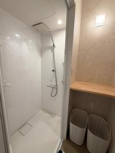 a bathroom with a shower and two stools in it at Three Maples Fujiyoshida in Fujiyoshida