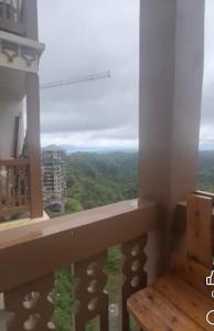 a view from a balcony with a table and a window at Twin Lakes Tagaytay Staycation by JC Staycation in Balibaguhan