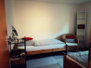 a bedroom with a bunk bed and a chair at Lüttje Tied in Walsrode